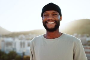 a person smiles outside
