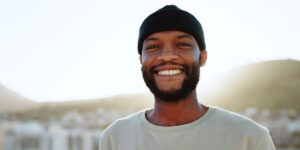 a person in an alumni group smiles while standing outside