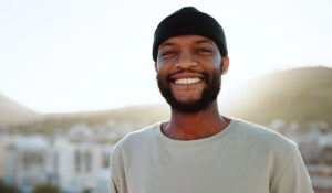 a person in an alumni group smiles outside