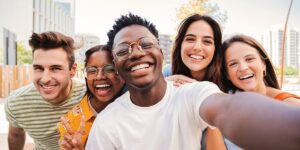 a group of people smile and take a selfie